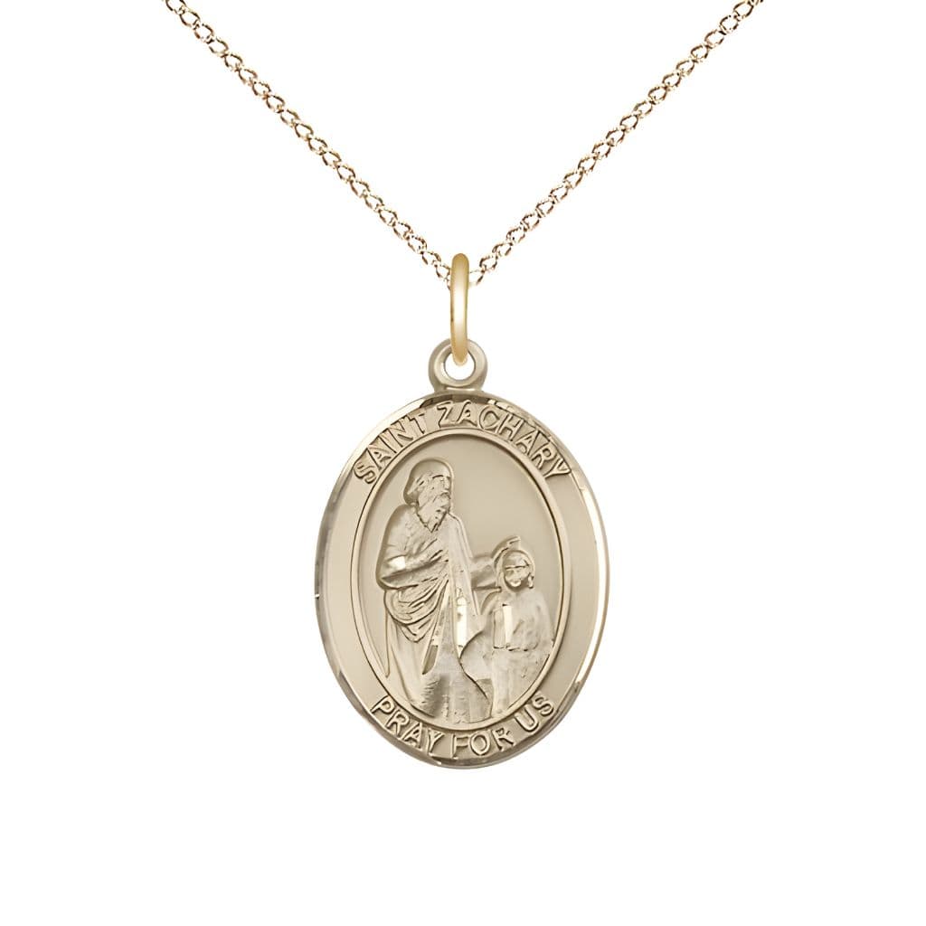 Bliss St. Zachary 14kt Gold Oval Medal Pendant with 14kt Gold Chain, Measures 3/4-inch tall by 1/2-inch wide.