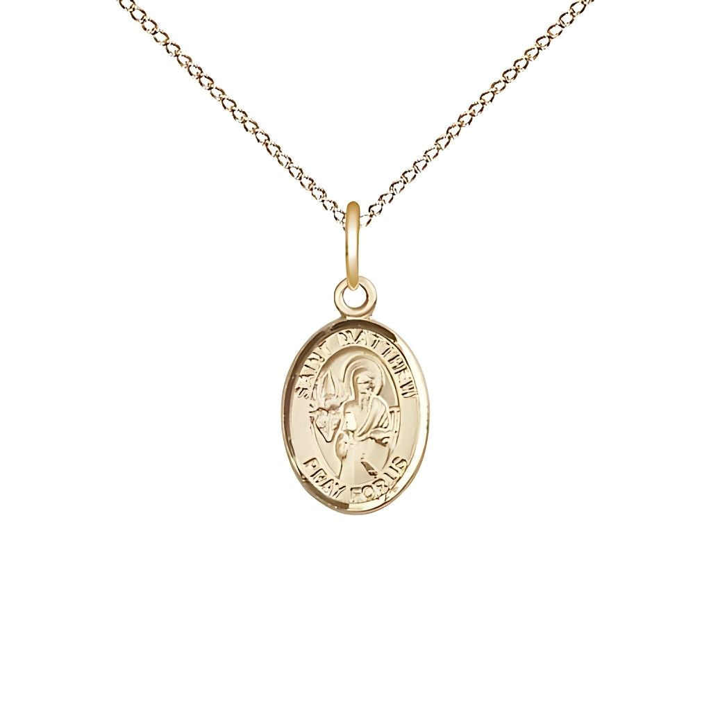 Bliss St. Matthew the Apostle 14kt Gold Oval Small Children Medal with 14kt Gold Chain, Measures 1/2-inch tall by 1/4-inch wide.