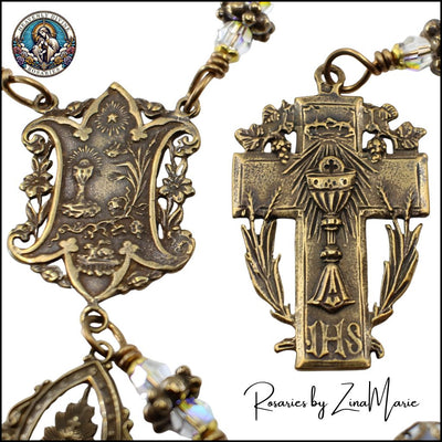 Close-up of a Rosary with intricate bronze Eucharist Cross and Centerpiece designs and 'IHS' symbol, branded 'Rosaries by Zina Marie', Heavenly Divine Rosaries