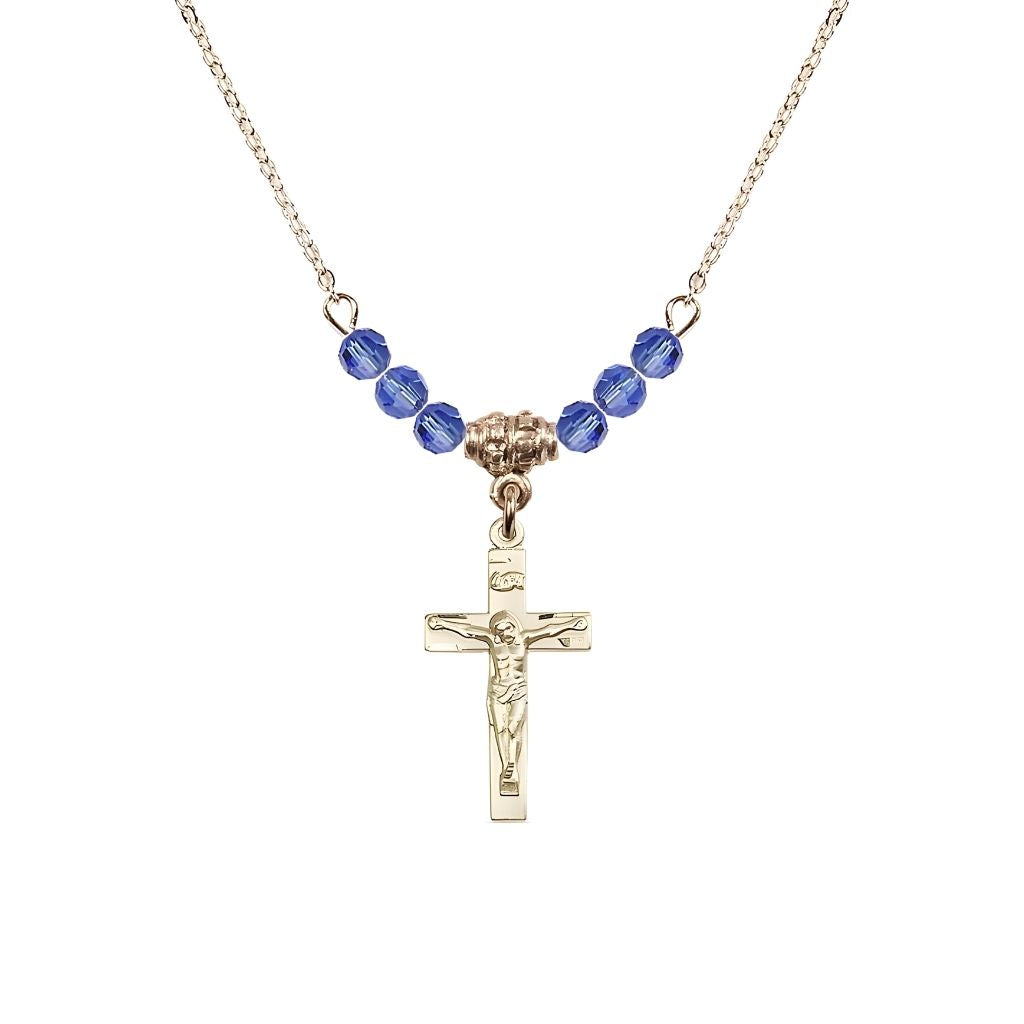 Bliss Gold-plated Holy Communion Crucifix Sapphire Beaded Necklace, Measures 1/2-inch tall by 3/8-inch wide