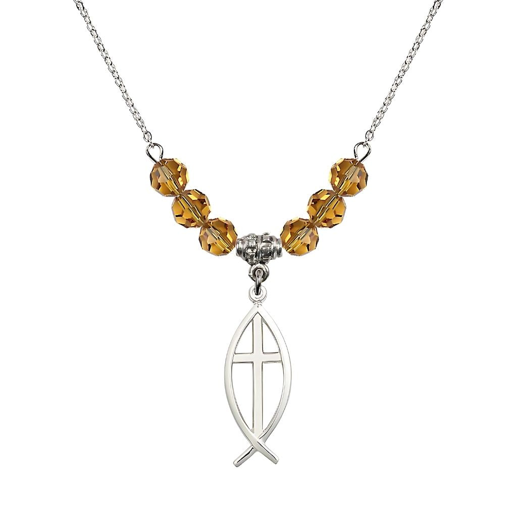 Bliss Fish Cross Crystal Birthstone Necklace with 18-inch Chain in Topaz, Medal 1 inch tall by 3/8 inch wide
