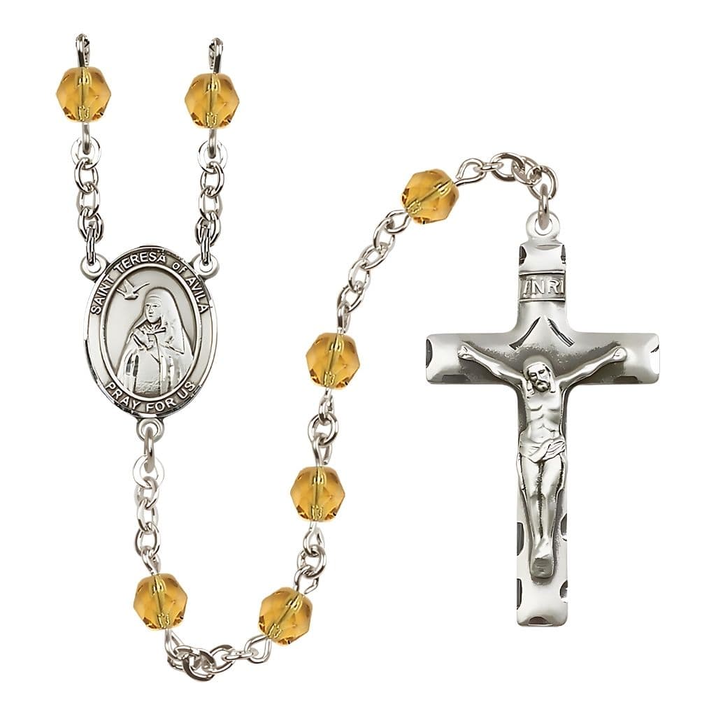 Bliss St. Teresa of Avila Engraved Birthstone 6mm Topaz Fire Polished Rosary with Pewter Centerpiece and Crucifix
