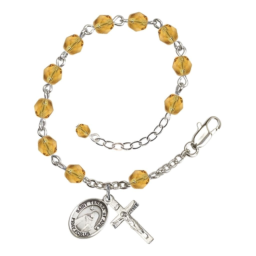 Bliss St. Teresa of Avila Birthstone Silver-plated 6mm Topaz Fire Polished Rosary Bracelet with Pewter Centerpiece and Crucifix