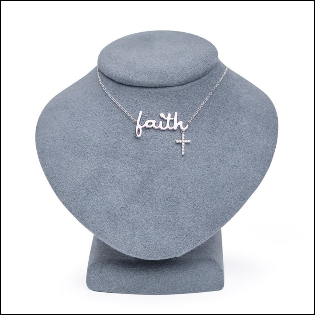 Singer Sterling Silver Necklace with 'faith' and cross pendant on a gray stand,