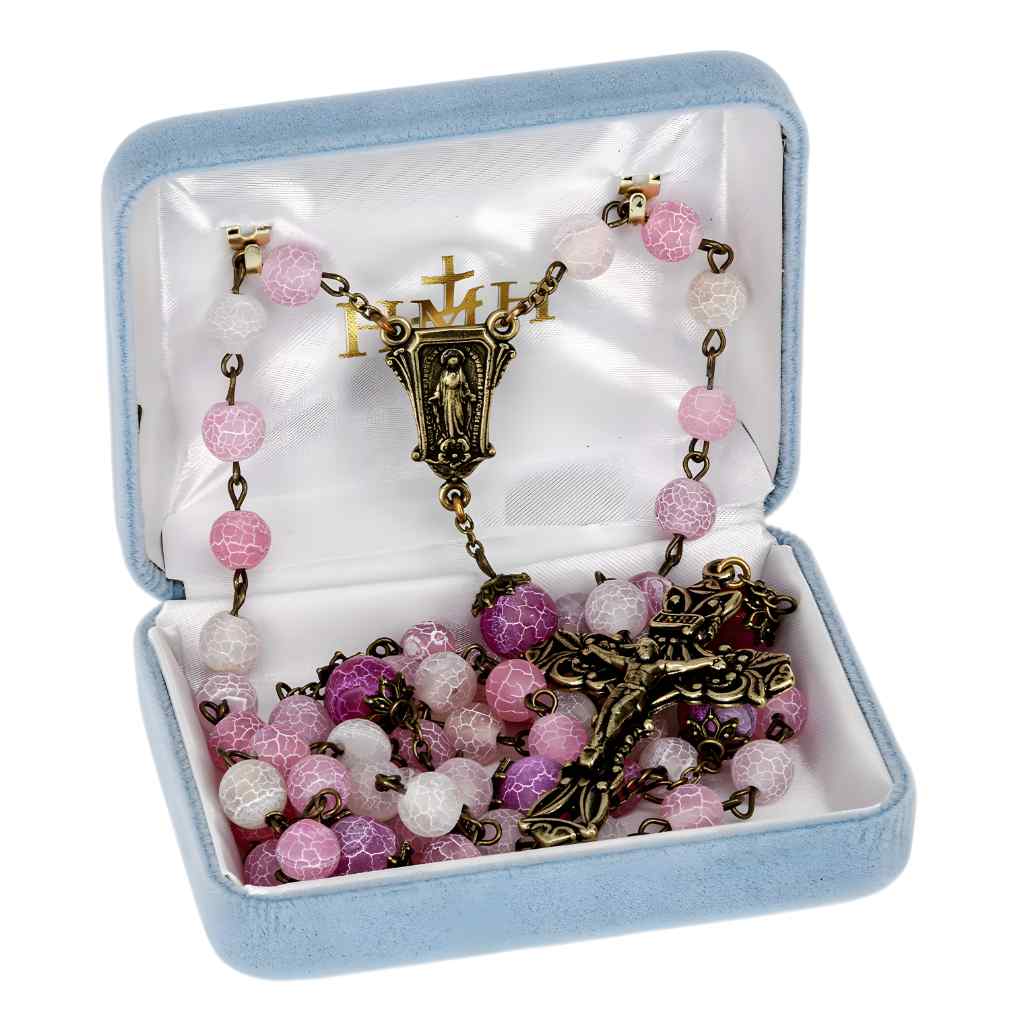 This rosary includes 8mm pink crackled glass beads with antique brass double capped 10mm pink Our Father beads. with brass pierced Miraculous medal centerpiece and a brass pierced crucifix in gift box (view 3)