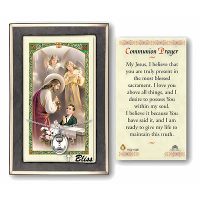 A boy's communion gift set featuring a sterling silver medal, both with religious imagery, and a laminated prayer card, Bliss Manufacturing